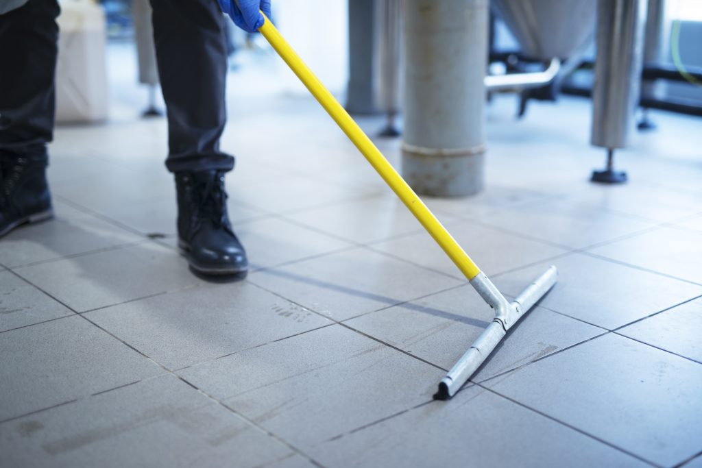close up mop cleaning industrial plant floor scaled