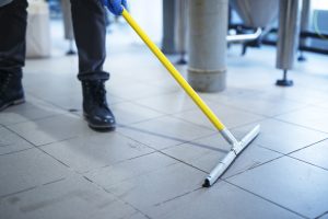 close up mop cleaning industrial plant floor scaled