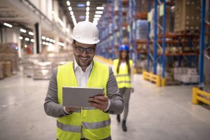 warehouse manager reading report tablet about successful delivery distribution warehouse logistics center scaled